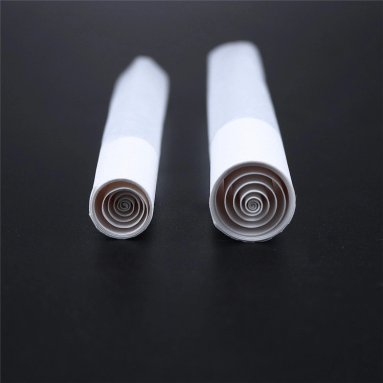 Close-up of two white spiral-tip pre-roll cones showing the rolled paper tip structure